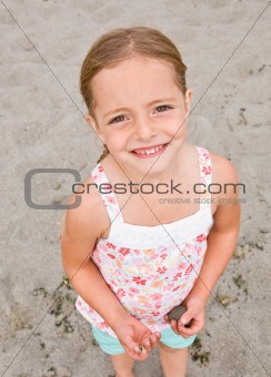 Girl holding rocks at beach