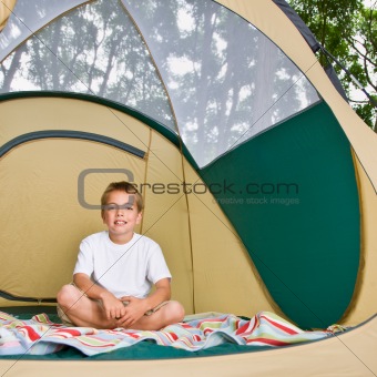Boy sitting in tent