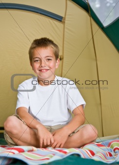 Boy sitting in tent