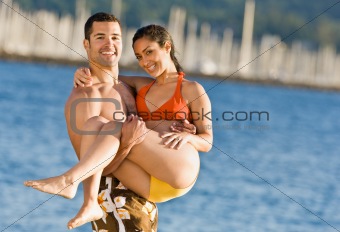 Boyfriend carrying girlfriend at beach