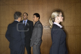 Businesswoman Walking by Businessmen