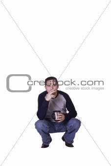 Crouched Mediterranean Man Smoking and Drinking Coffee