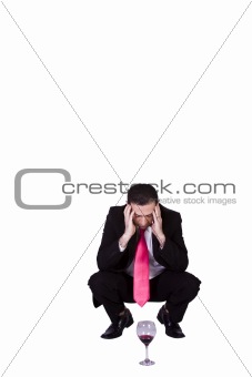 Crouched Mediterranean Man Drinking