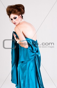Attractive Young Woman Wearing a Blue Satin Dress