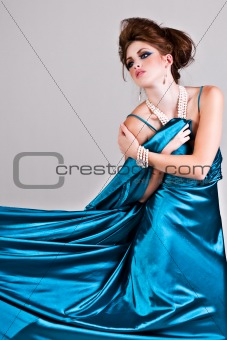 Attractive Young Woman Wearing a Blue Satin Dress