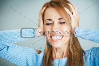 frustrated woman covering ears with hands