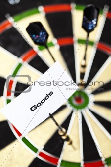 Dartboard with three darts in a bulls eye