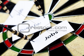 Dart on bulls eye target of dartboard