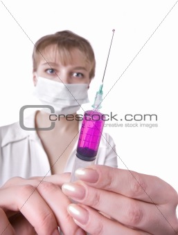 female doctor with mask holding syringe on a white 