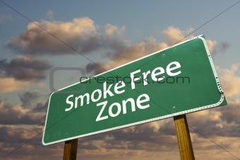 Smoke Free Zone Green Road Sign In Front of Dramatic Clouds and Sky.