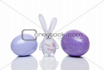 Cute Easter bunny with big ears between easter eggs