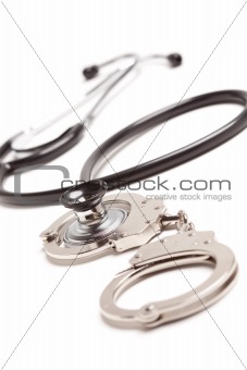 Stethoscope and Handcuffs Isolated on a White Background.