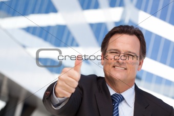 Handsome, Confident Businessman Outside of Corporate Building with Thumbs Up.