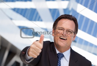 Handsome, Confident Businessman Outside of Corporate Building with Thumbs Up.
