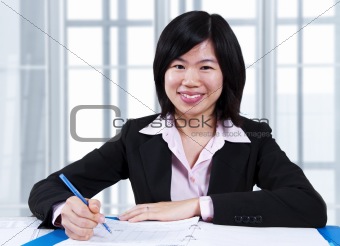 Asian woman working in office