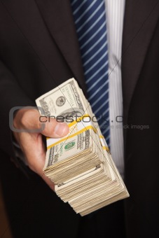 Businessman Handing Over Stack of One Hundred Dollar Bills.