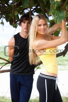 Young Couple Standing Under Tree