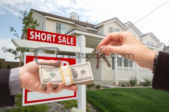 Handing Over Cash For House Keys and Short Sale Real Estate Sign in Front of Home.