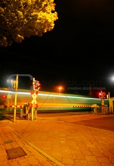 Railroad crossing at night of a Metro
