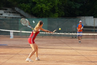 blond girl playing tennis