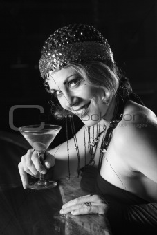 Retro female sitting at bar with martini.