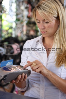 Woman using debit machine