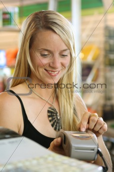 Woman using debit terminal