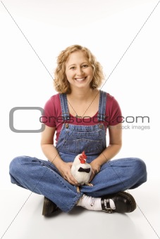Adult female holding  rooster wearing bow tie.