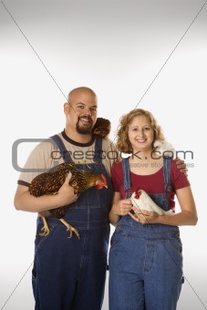 Caucasian woman and man with chickens.