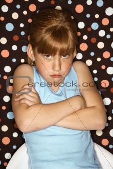 Girl pouting with arms crossed.