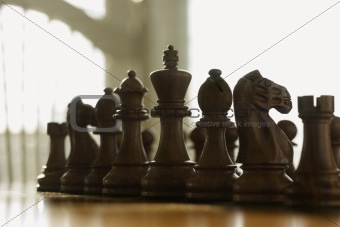 Chess pieces set up on board.