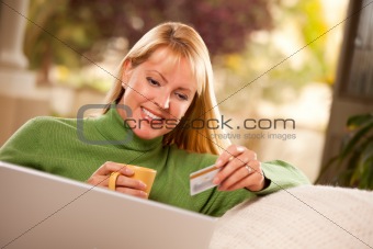 Beautiful Woman with Credit Card Using Her Laptop.