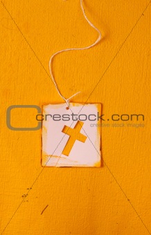 Close up of handmade paper tag with holy cross