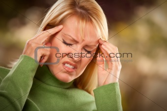 Grimacing Woman Suffering a Painful Headache.