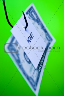 Dollar sign on piece of paper on hook