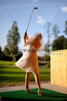 Bride playing golf