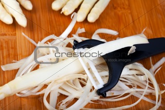 raw white asparagus on a wooden blank