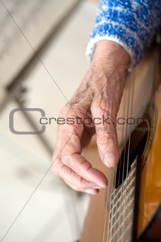 Old hands on guitar