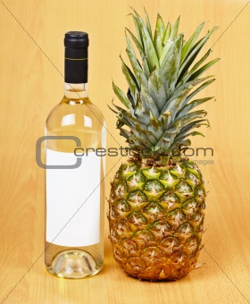 Bottle of white wine and large pineapple