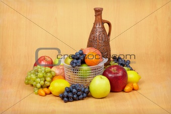 Still life of fruit and ceramic bottle