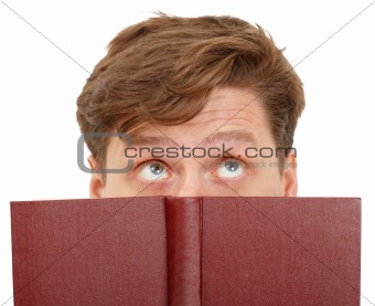 Man dreamily reading book - close-up of eyes