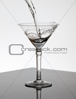 Water pouring into a Martini glass