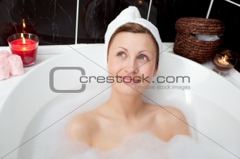 Radiant woman relaxing in a bubble bath 