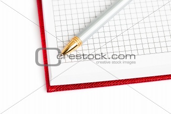 red notebook with silver pen