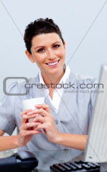 Smiling business woman drinking coffee