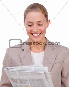Confident businesswoman reading a newspaper 