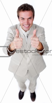 Victorious businessman with thumbs up 
