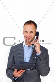 Smiling businessman using a phone 