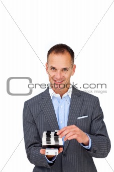 Assertive businessman consulting a business card holder 