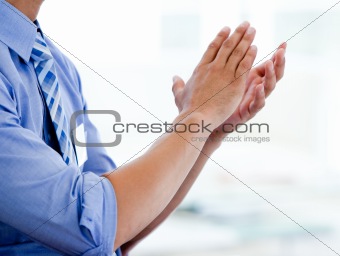 Close-up of a businessman clapping 